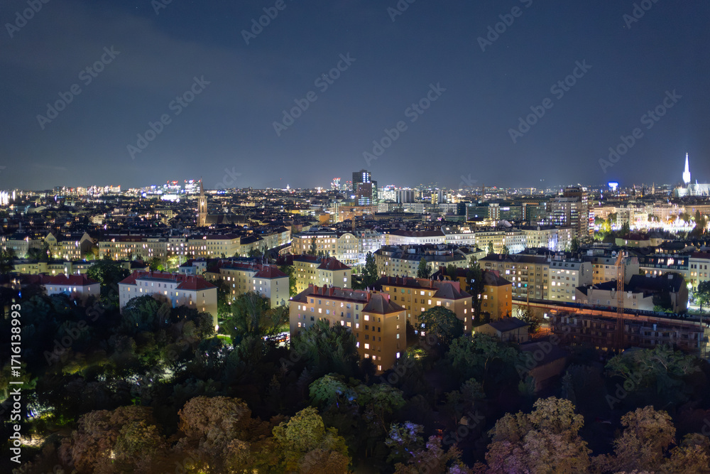 Fototapeta premium Vibrant Nighttime Cityscape of Vienna with Illuminated Buildings and a Clear Starry Sky