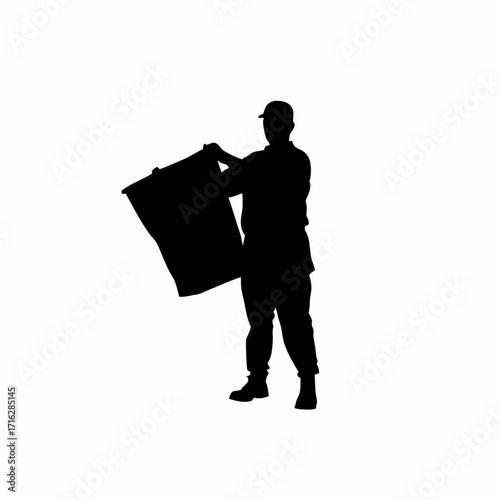 Silhouette of worker loading plastic pellets into injection molding machine hopper isolated on white background