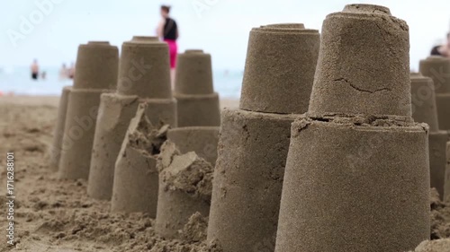 Cylindrical figures made of sand on the beach