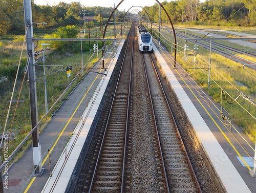 French regional express train pulling into a small station
