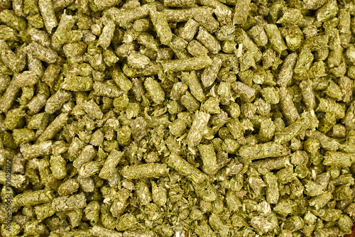 flat lay pile of green timothy grass pellet for rodent pet food feed texture background