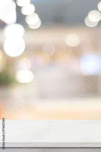 Empty vertical white table top, counter, desk background over blur  bokeh background, White marble stone table, shelf and blurred kitchen restaurant for food, product display mockup, template