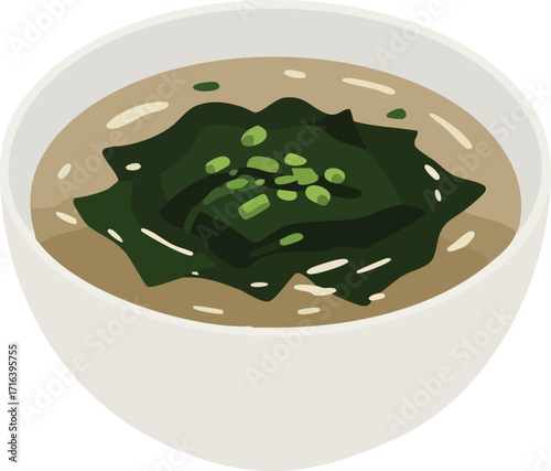 A bowl of miso soup with seaweed and green onions.