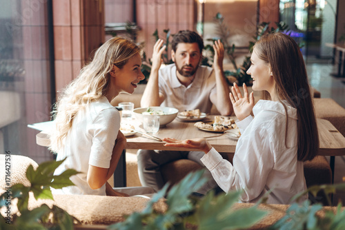 Friends talking during restaurant lunch creating awkward moment