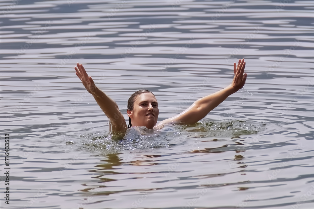 Fototapeta premium Young woman swimming in the lake.