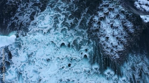 Dramatic aerial top view footage of big power ocean waves with white foam on stormy day cinematic style
