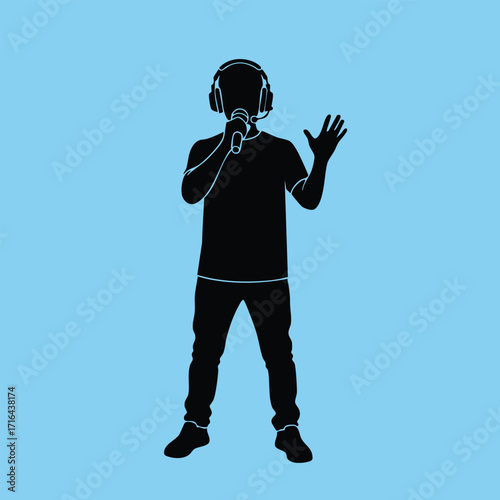 Silhouette of a person wearing headphones and holding a microphone while singing or speaking on a blue background