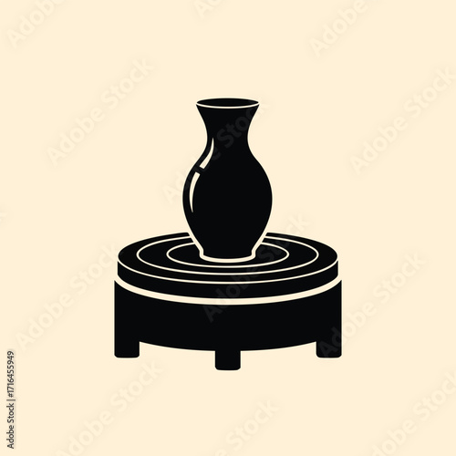 Black silhouette of a pottery vase on a circular pottery wheel representing ceramic art and craftsmanship