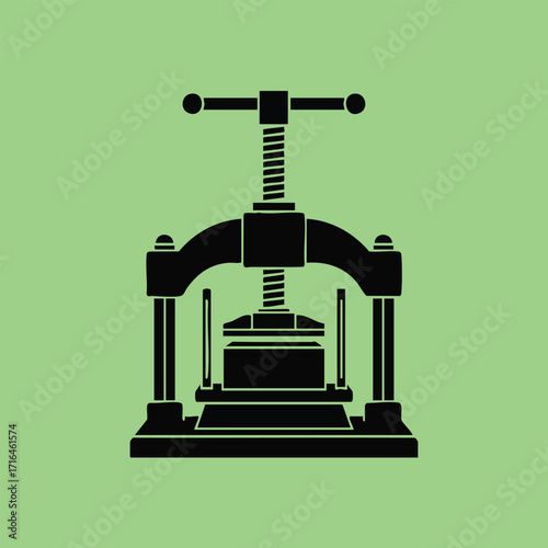 Black silhouette of a vintage bookbinding press with screw mechanism on a solid green background