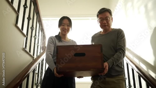 Family moving upstairs box
