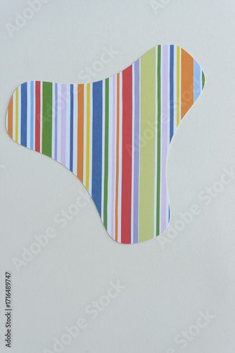 abstract machine-cut paper shape with stripes on blank paper