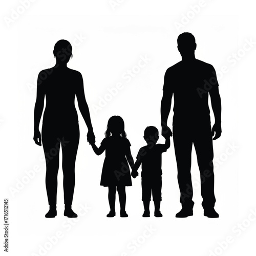 Silhouette of a loving family with parents holding hands with their two young children standing together