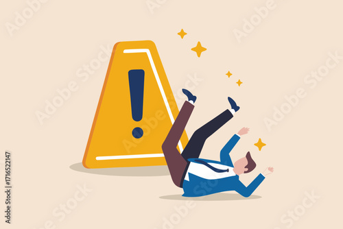 Businessman falling down next to a yellow warning sign with an exclamation mark and sparkling stars