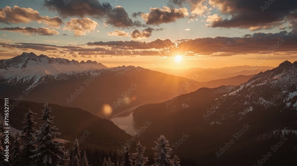 Obraz premium A breathtaking mountain vista at sunset, showcasing snow-capped peaks and a golden, warm glow.