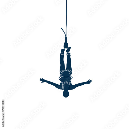 Silhouette of a person hanging upside down performing a bungee jump with arms outstretched and safety harness