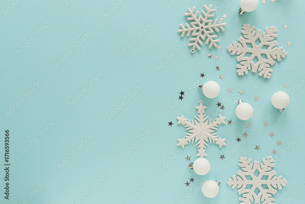 Fototapeta premium White Christmas Ornaments and Snowflakes on Light Blue Background