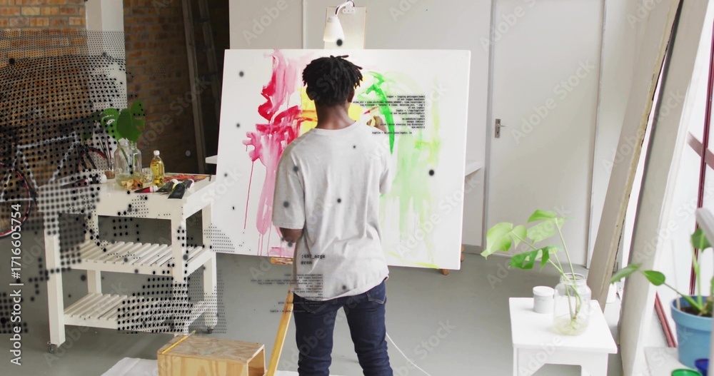 Naklejka premium Painting artist applying red and green strokes on canvas in art studio, with easel and palette