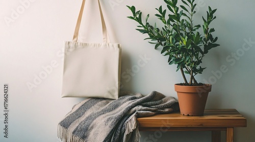Wallpaper Mural Tote bag hanging on wall near plant in pot on wooden surface. Torontodigital.ca