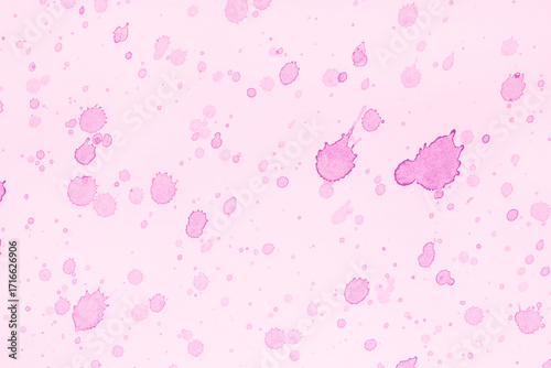 close up of pink paint splashes on canvas