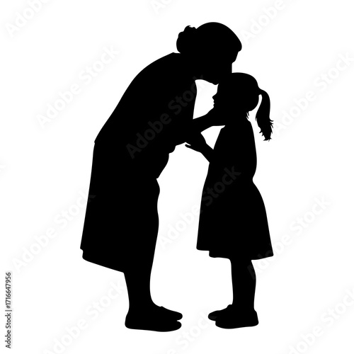 Woman kissing childs forehead silhouette