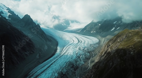 Majestic Glacier Flowing Between Rugged Mountains Under a Cloudy Sky.