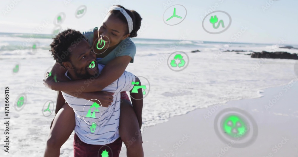 Naklejka premium Carrying couple wrapping arms on sandy beach by ocean, featuring green environmental icons