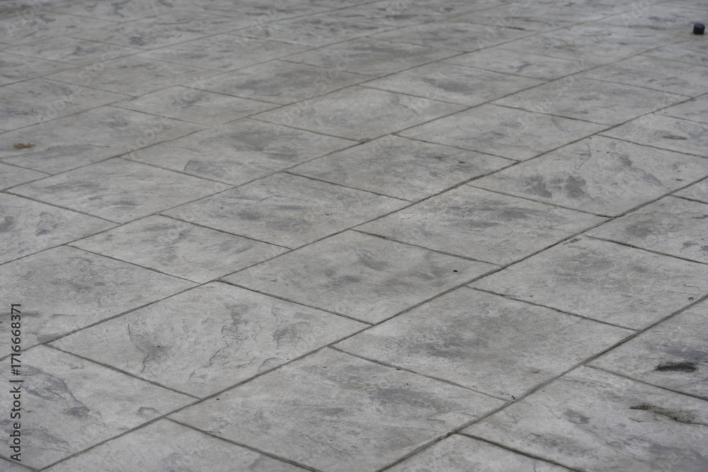 Fototapeta premium Gray stone tile floor background with modern industrial texture. Concrete pavement pattern for architecture, design, business presentation, or construction concept.