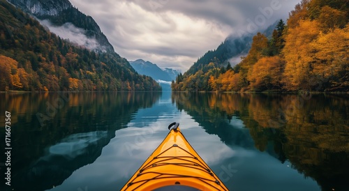 Kayaking on a Calm Lake Surrounded by Vibrant Autumn Trees in the Mountains