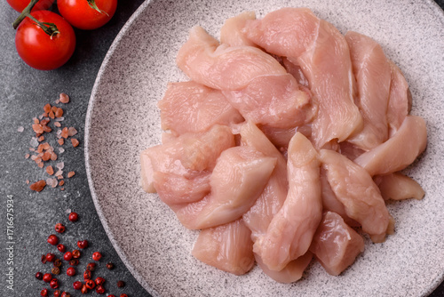 Tableau sur toile Strips of raw chicken or turkey fillet, skinless and boneless poultry breast
