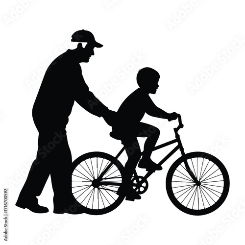 Father teaching son to ride bicycle silhouette