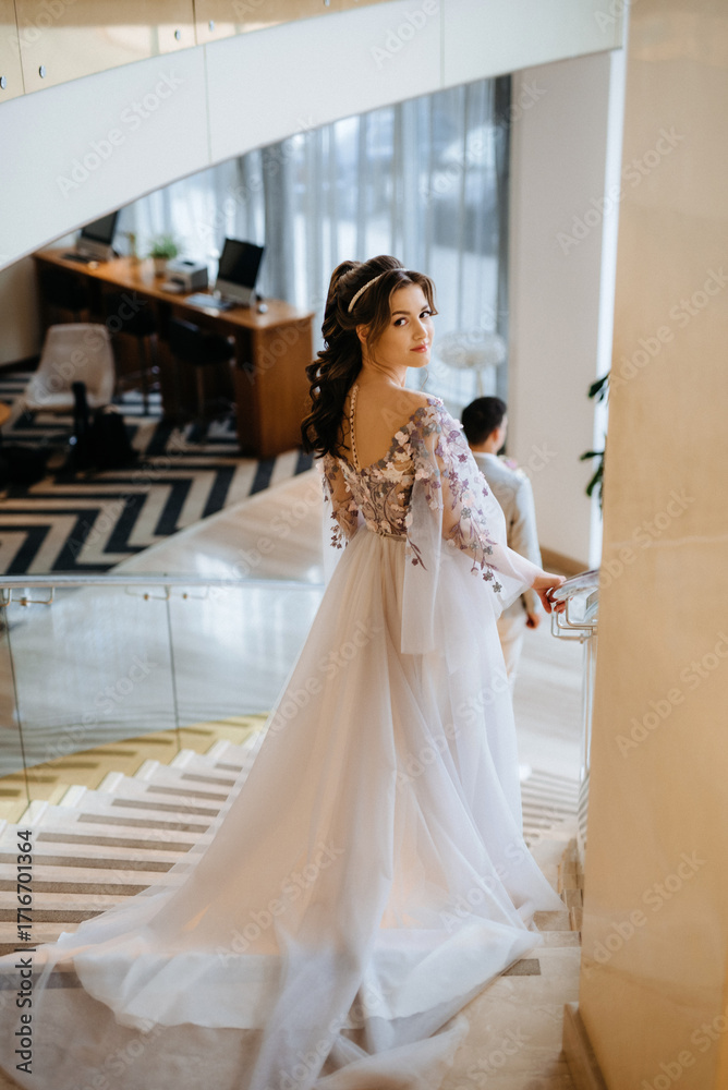 Fototapeta premium meeting of the bride and groom on the hotel stairs