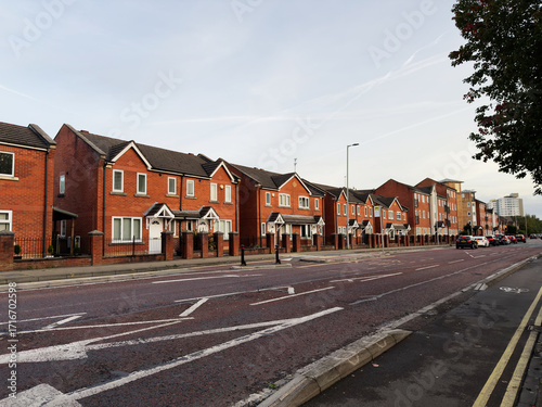 Residential street view of brick houses in Manchester, UK at daytime