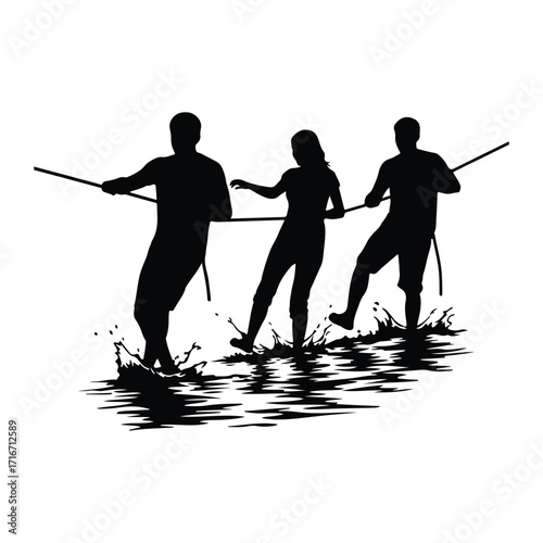 People pulling rope in water tug of war splashing
