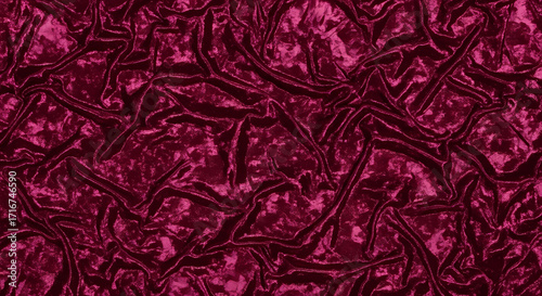 Rich crushed velvet fabric texture in deep magenta, showcasing luxurious folds and subtle shimmer, perfect for elegant backgrounds and design projects.