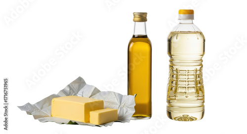 Vibrant yellow butter in silver foil, golden olive oil in clear bottle, light yellow vegetable cooking oil in clear bottle on transparent background with soft reflections and copy space, bright