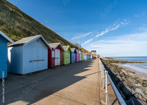 Beach huts on the promenade in the seaside town of Sheringham, Norfolk Coast