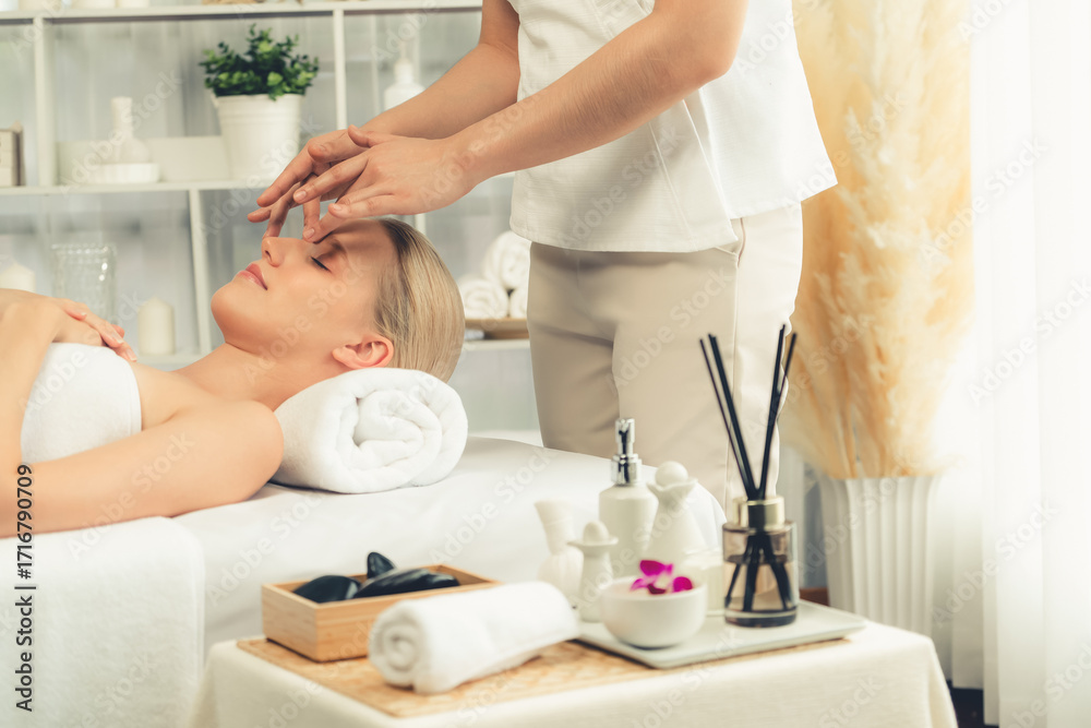Obraz premium Caucasian woman enjoying relaxing anti-stress head massage and pampering facial beauty skin recreation leisure in dayspa modern light ambient at luxury resort or hotel spa salon. Quiescent