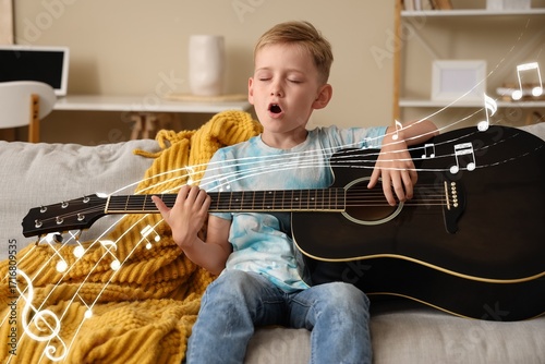 Cute little boy playing gui...