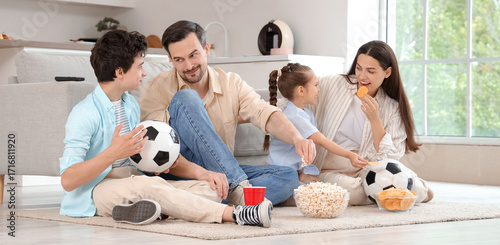Happy family with snacks an...