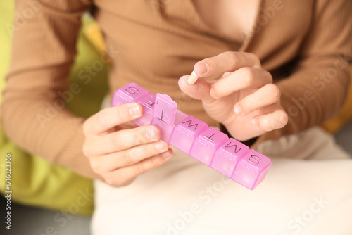 Young woman with pill organ...