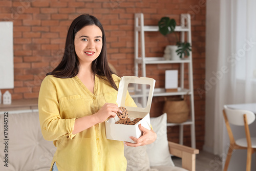 Young woman with box of coo...