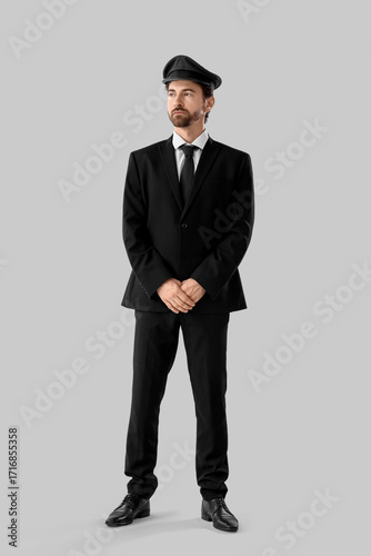 Handsome chauffeur on grey ...
