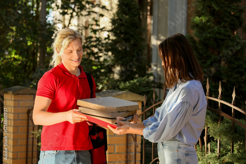 Male courier delivering piz...