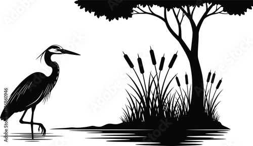 Silhouette of a heron standing in water near cattails and a tree with dense foliage in black and white
