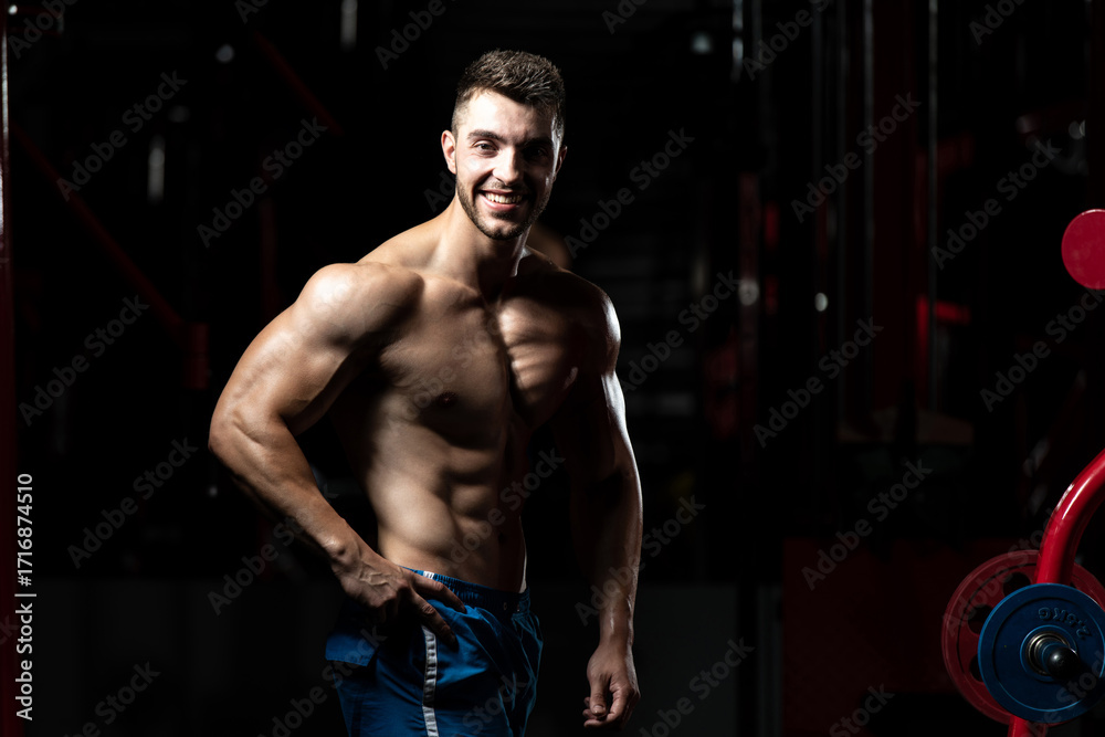 Fototapeta premium Man In Gym Showing His Well Trained Body