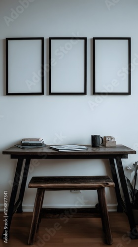 Wallpaper Mural Modern minimalist study area featuring a rustic wood desk and three blank wall frames. Torontodigital.ca