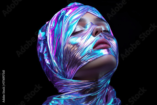 Metallic facial wrap with shimmering effect enhances model features, creating striking visual
