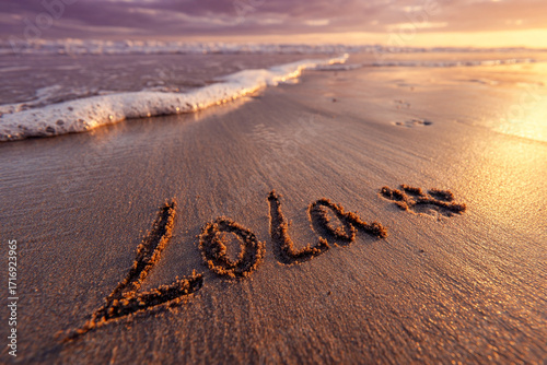 Golden Hour Beach Scene with the Name Lola Written in Smooth Sand and Sunset Glow over Serene Ocean Shoreline