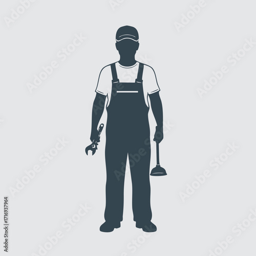 Silhouette of a plumber holding a wrench and a plunger wearing overalls and a cap on a plain background