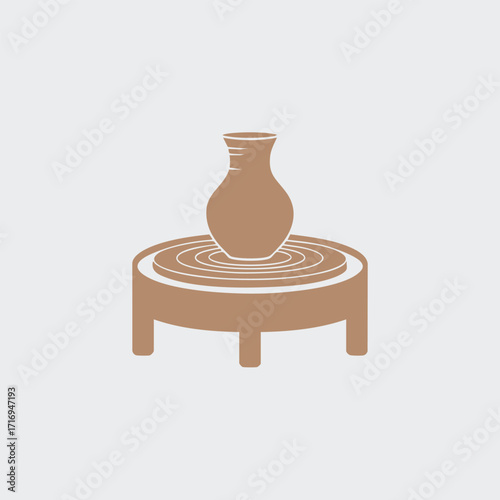 Minimalist icon of a pottery wheel with a clay vase being shaped on a spinning round table in brown tones